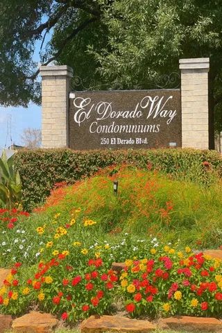 a sign that is in front of flowers