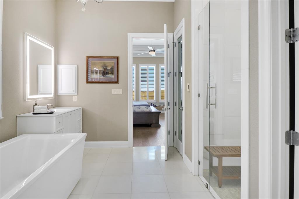 1809 Shade Tree Street Fort Worth, TX 76008 - Photo 11 of 28 Marble flooring and shower. 2 vanities with lighted mirrors, large soaking tub and linen closet behind door