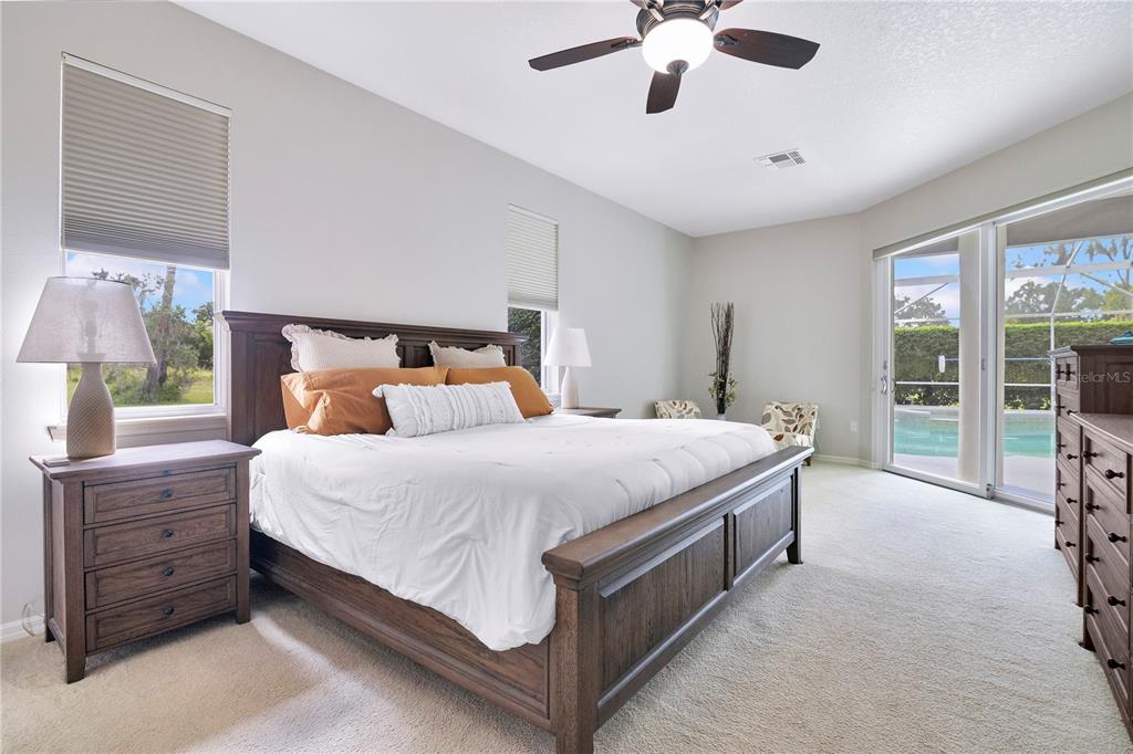 10216 Trout Road Orlando, FL 32836 - Photo 11 of 33 a bedroom with a large bed and a chandelier