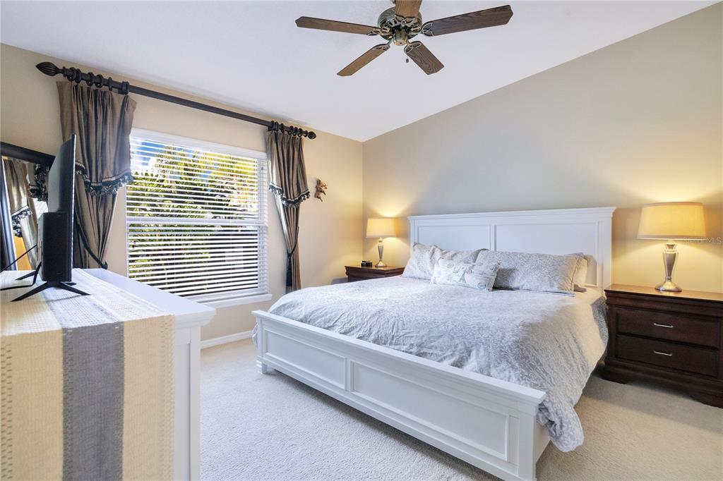 10216 Trout Road Orlando, FL 32836 - Photo 15 of 33 a bedroom with a bed dresser and wooden floor