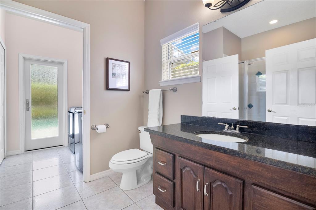 10216 Trout Road Orlando, FL 32836 - Photo 19 of 33 a bathroom with a granite countertop sink toilet and shower