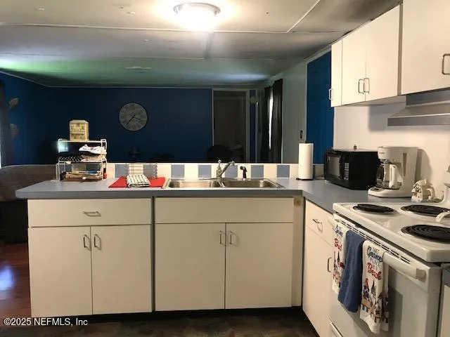 a kitchen with a stove cabinets and window