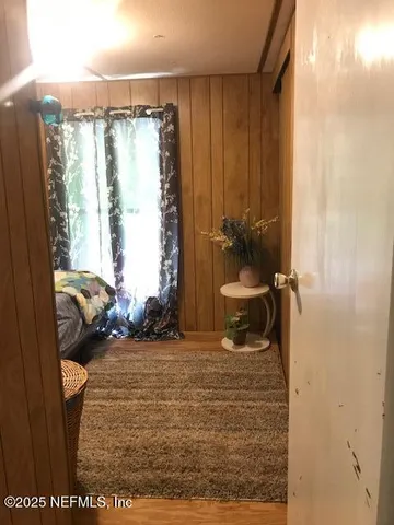 a bedroom with a bed and a mirror