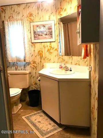 a white toilet sitting next to a shower curtain