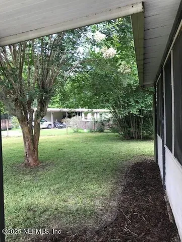 a view of backyard with large trees