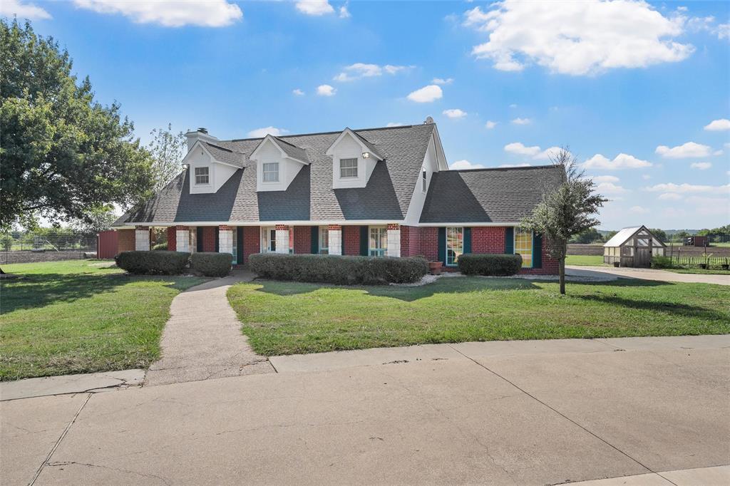 5112 Old Caufield Ranch Road McGregor, TX 76657 - Photo 6 of 38 Cape cod house with a shingled roof, brick siding, and covered porch