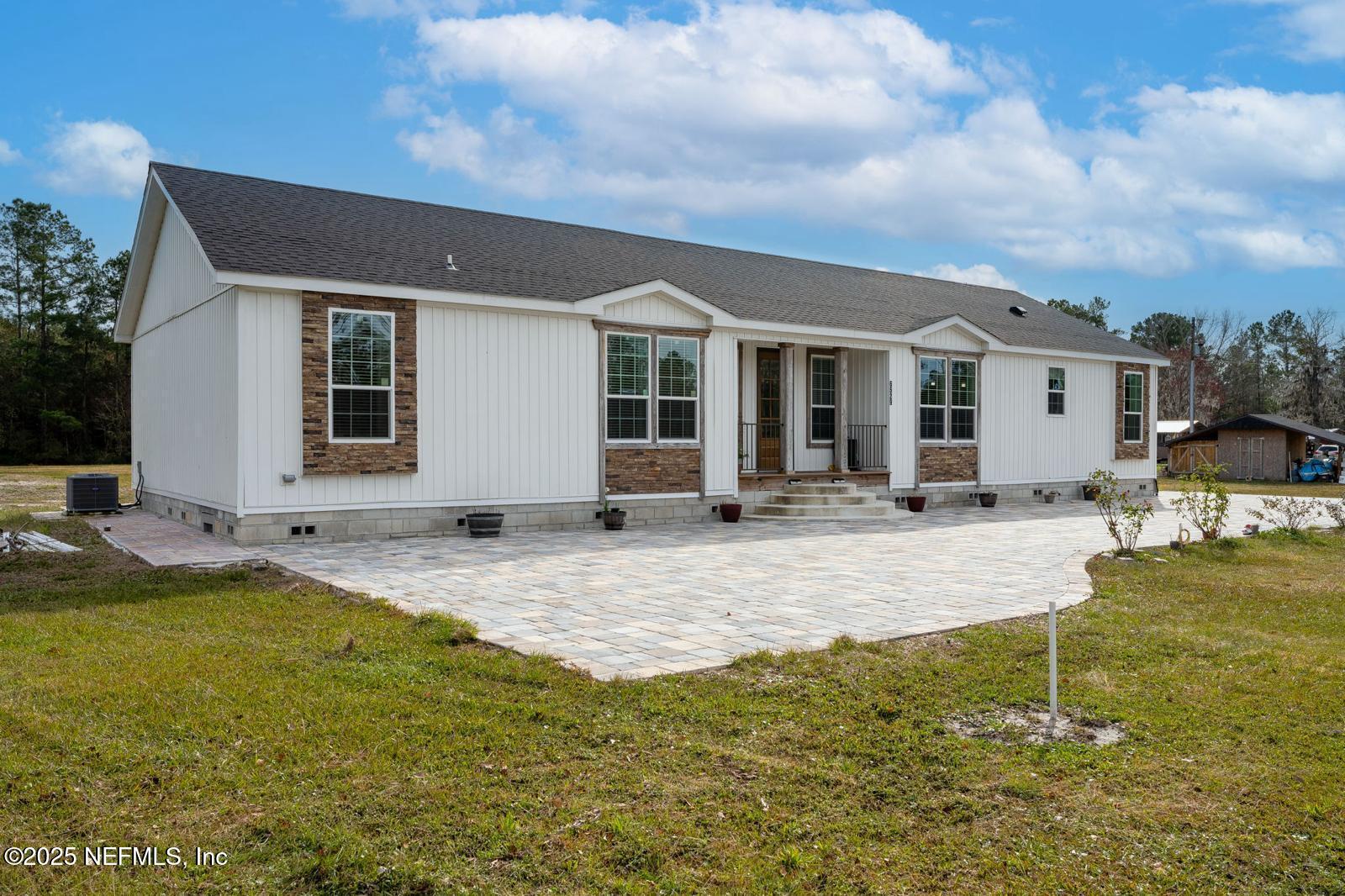 6529 County Road 121 Bryceville, FL 32009 - Photo 1 of 39 a view of a house with swimming pool and sitting area