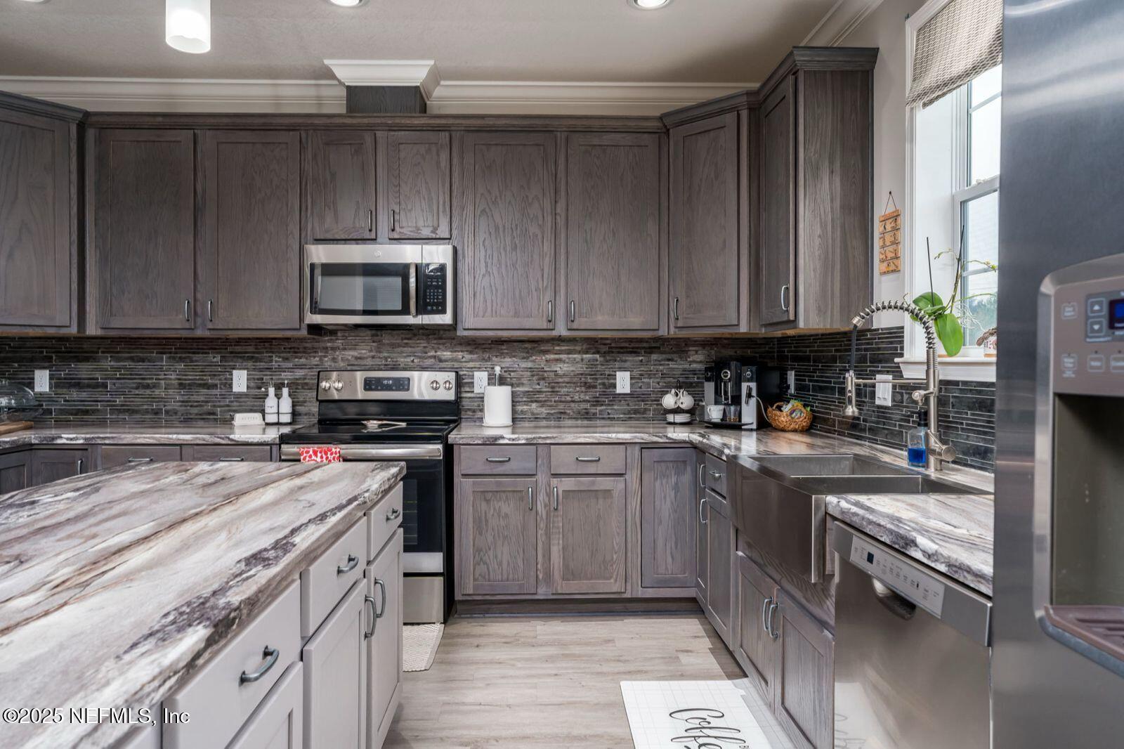 6529 County Road 121 Bryceville, FL 32009 - Photo 11 of 39 a kitchen with a sink a stove and cabinets