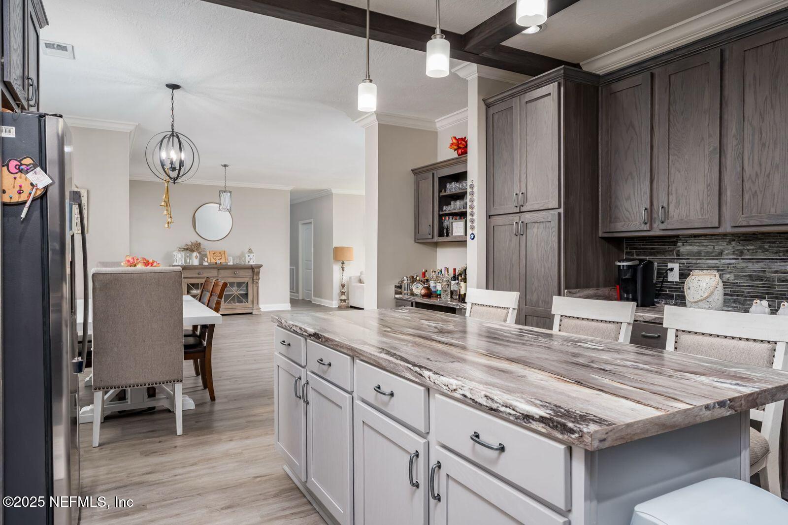 6529 County Road 121 Bryceville, FL 32009 - Photo 12 of 39 a kitchen with granite countertop a table chairs stove and cabinets