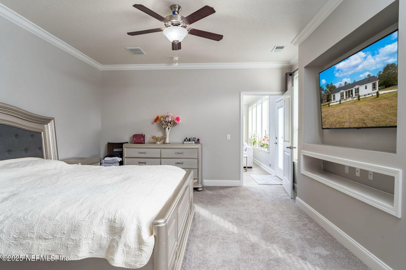 6529 County Road 121 Bryceville, FL 32009 - Photo 15 of 39 a bed room with a bed and a television
