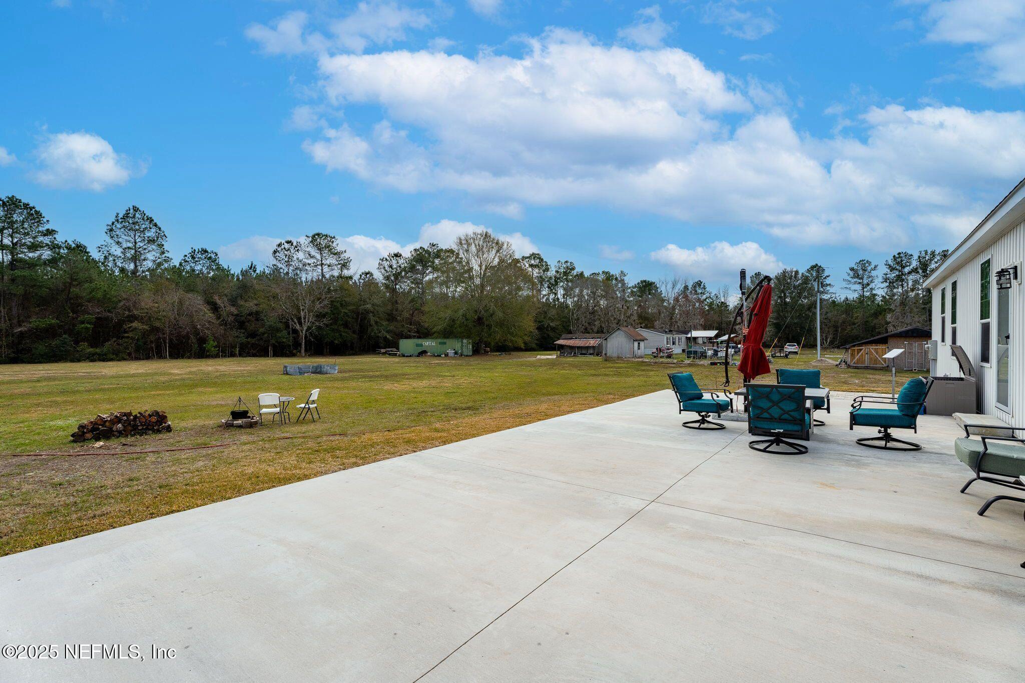 6529 County Road 121 Bryceville, FL 32009 - Photo 24 of 39 a view of a swimming pool and lake