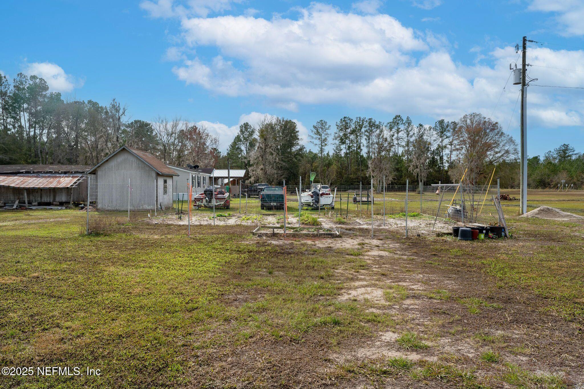 6529 County Road 121 Bryceville, FL 32009 - Photo 28 of 39 a swimming pool with outdoor seating and yard