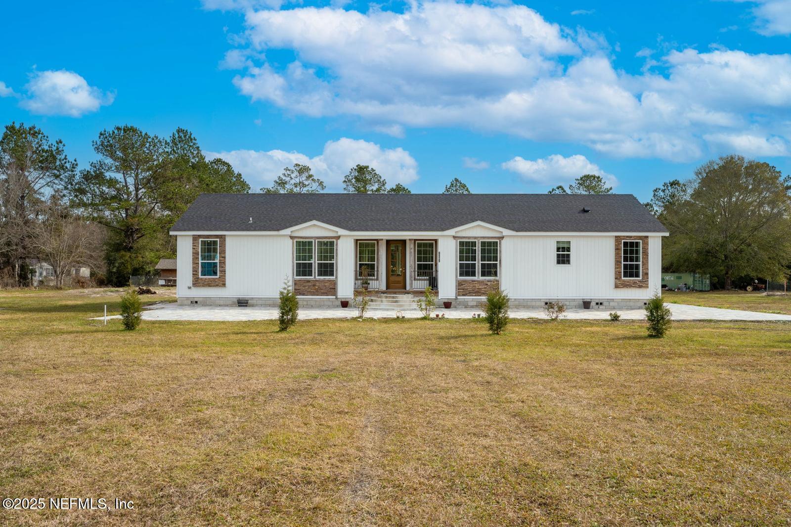 6529 County Road 121 Bryceville, FL 32009 - Photo 3 of 39 a view of a house with swimming pool and a yard