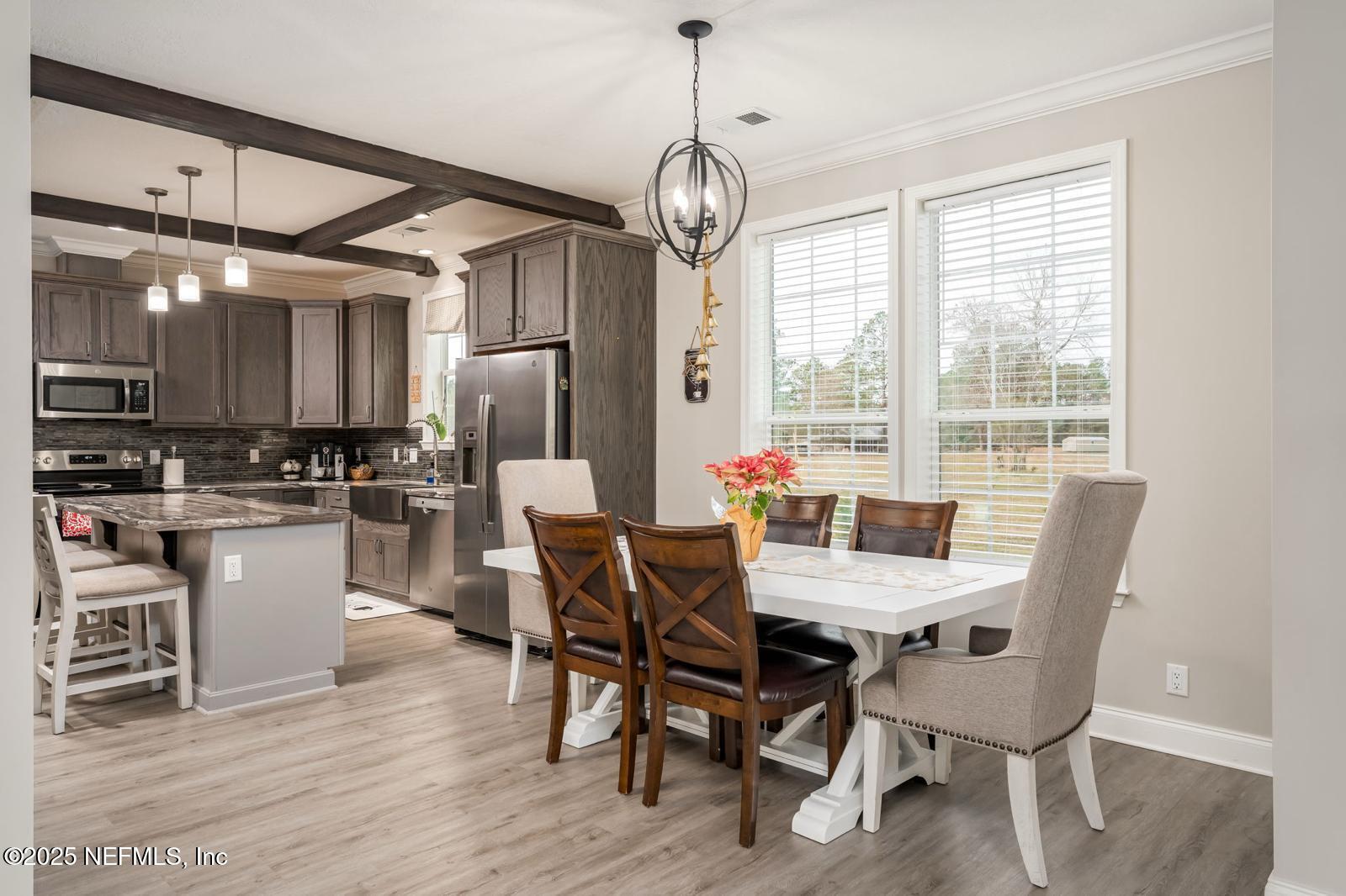 6529 County Road 121 Bryceville, FL 32009 - Photo 8 of 39 a view of a dining room with furniture window and wooden floor