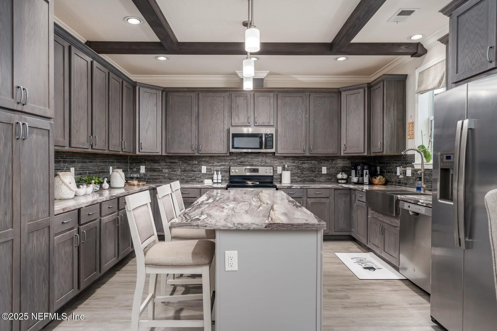 6529 County Road 121 Bryceville, FL 32009 - Photo 9 of 39 a kitchen with granite countertop a sink stainless steel appliances and cabinets