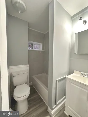 a white toilet sitting next to a bathroom sink