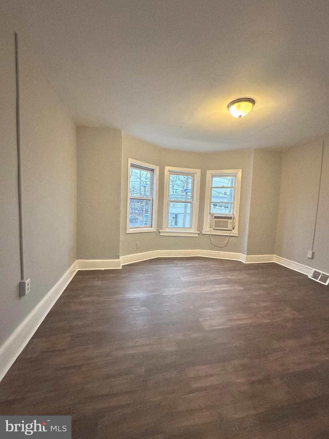 1109 Nottingham Way Hamilton, NJ 08609 - Photo 14 of 17 an empty room with wooden floor and windows