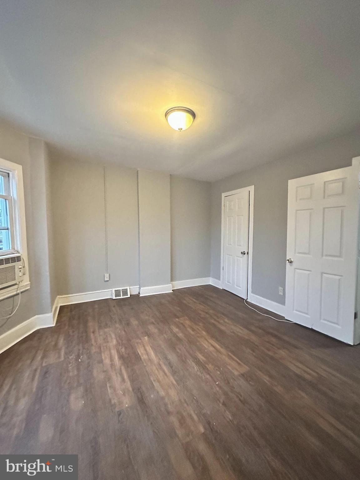 1109 Nottingham Way Hamilton, NJ 08609 - Photo 15 of 17 a view of an empty room with wooden floor and a window