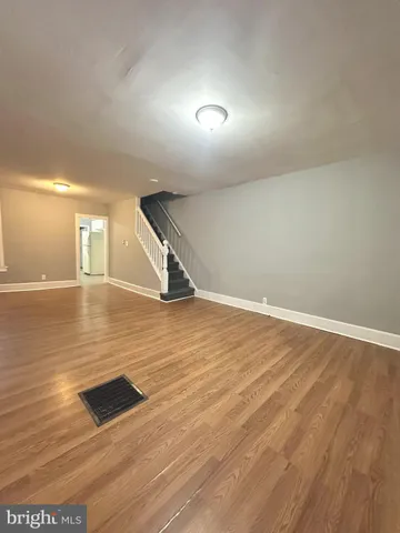 an empty room with wooden floor