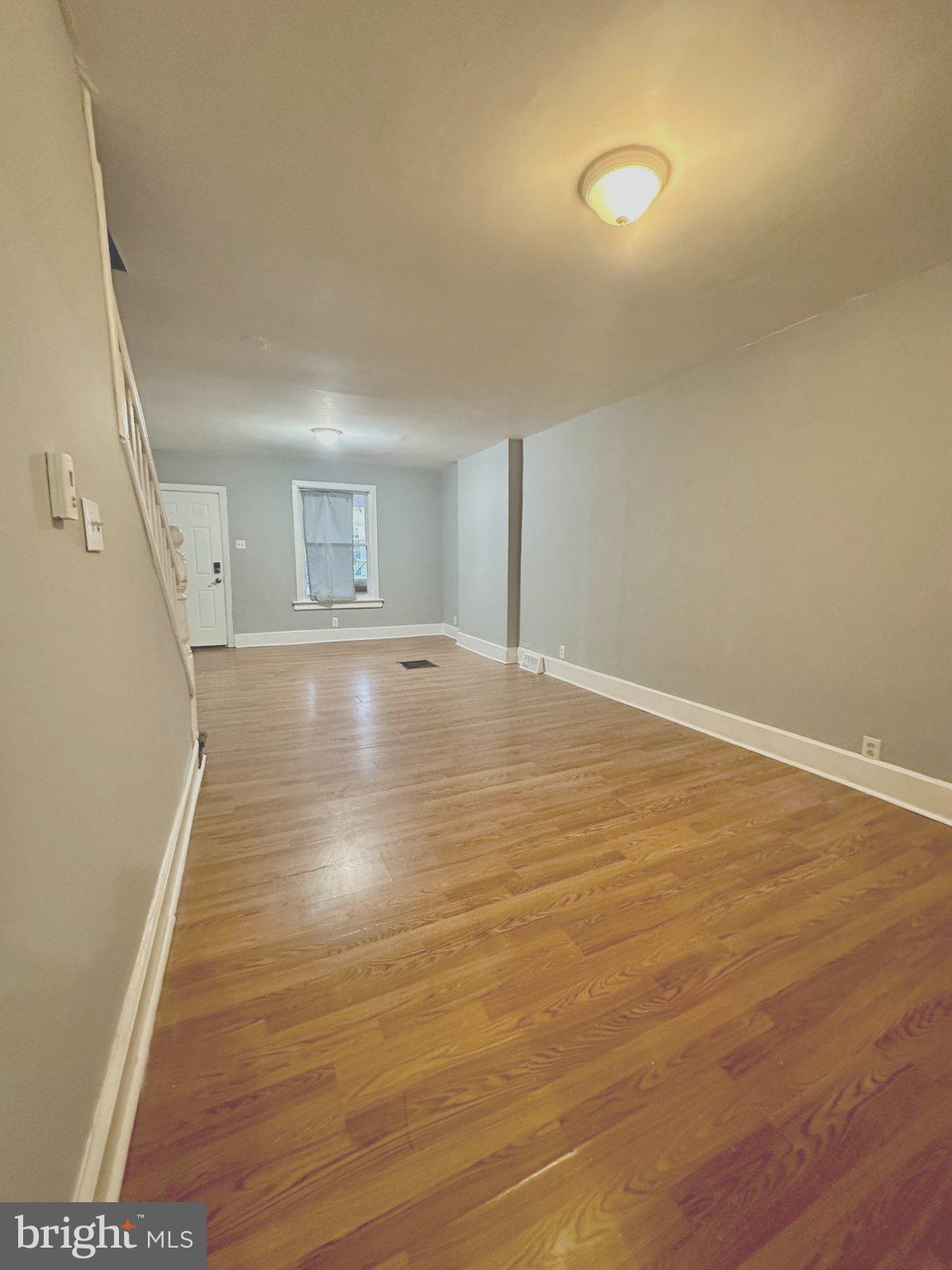1109 Nottingham Way Hamilton, NJ 08609 - Photo 4 of 17 a view of an empty room with wooden floor and a window