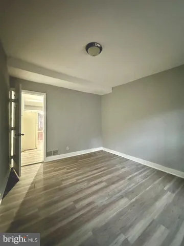 a view of an empty room and wooden floor