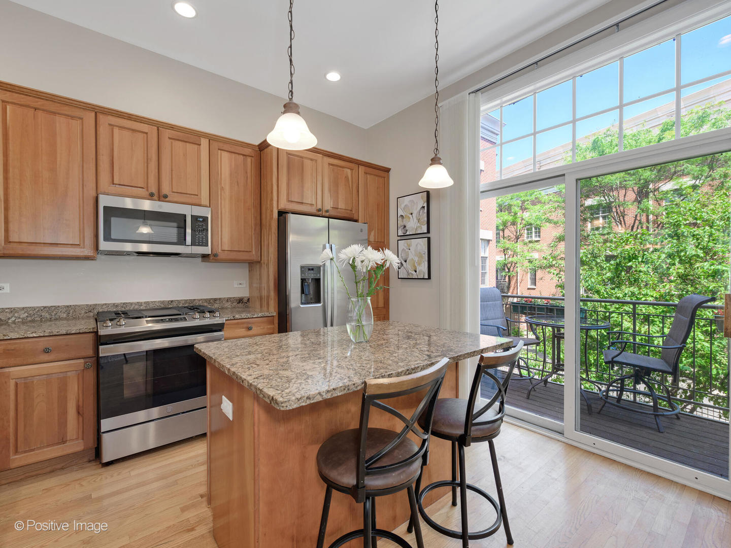 855 North May Street, Unit E Chicago, IL 60642 - Photo 8 of 30 a kitchen with microwave a stove and furniture