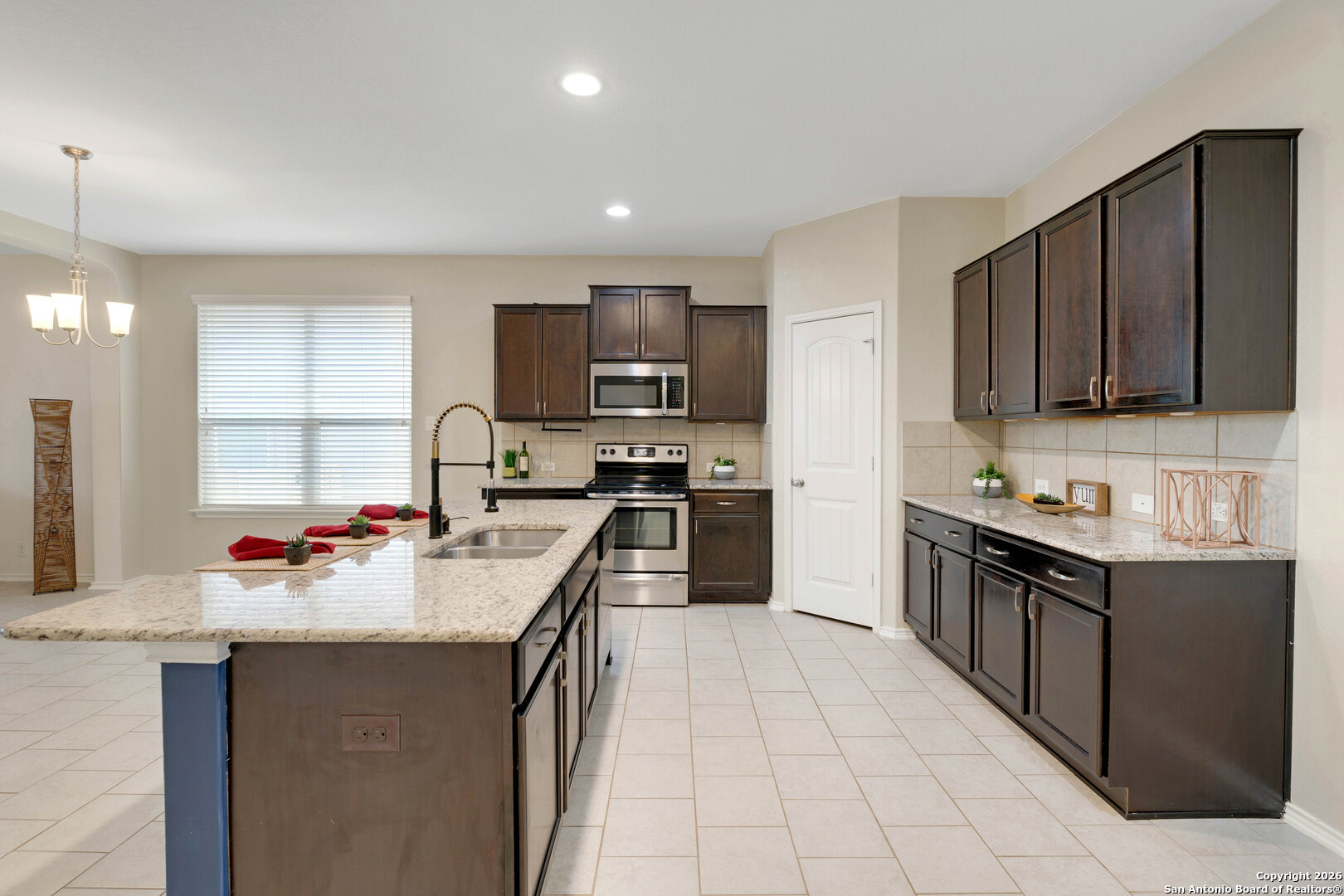 428 Kings Way Cibolo, TX 78108 - Photo 4 of 30 a kitchen with a sink stove top oven and refrigerator
