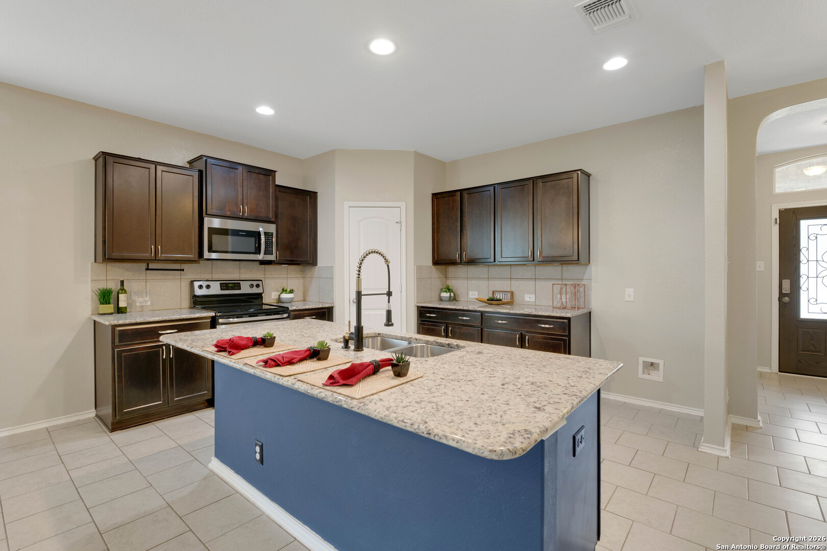 428 Kings Way Cibolo, TX 78108 - Photo 5 of 30 a kitchen with granite countertop kitchen island stainless steel appliances a stove refrigerator sink and cabinets