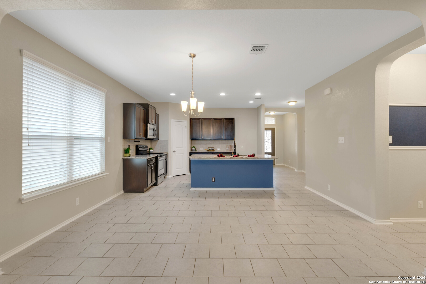 428 Kings Way Cibolo, TX 78108 - Photo 8 of 30 a large kitchen with stainless steel appliances kitchen island granite countertop a refrigerator and a stove top oven