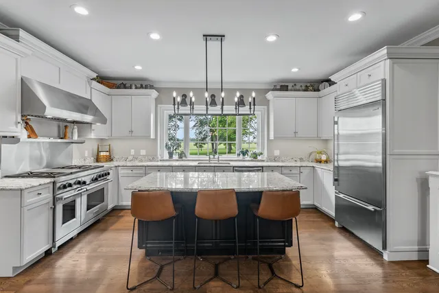 a kitchen with stainless steel appliances a stove a sink and a refrigerator
