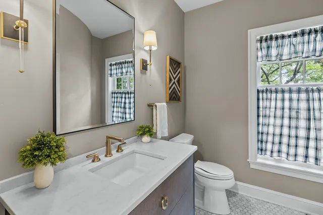 a bathroom with a sink toilet and a mirror