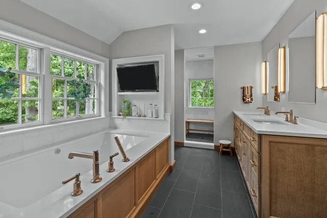 a bathroom with a double vanity sink and a large mirror