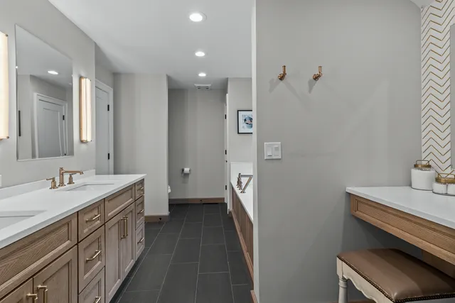 a bathroom with a double vanity sink and mirror