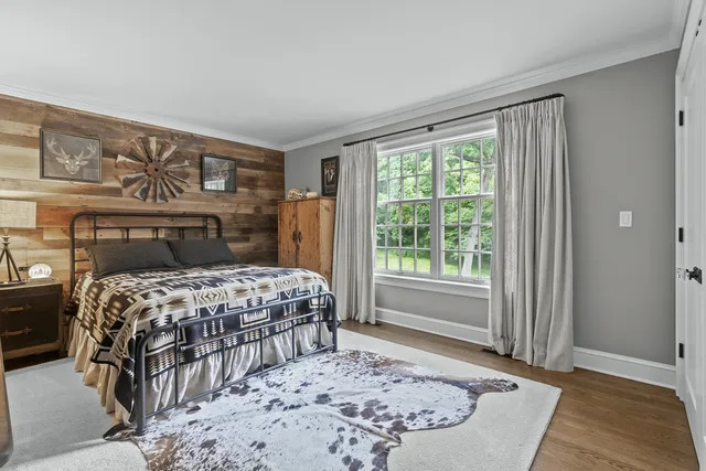 a bedroom with a large bed and a window