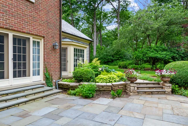 a view of a house with potted plants