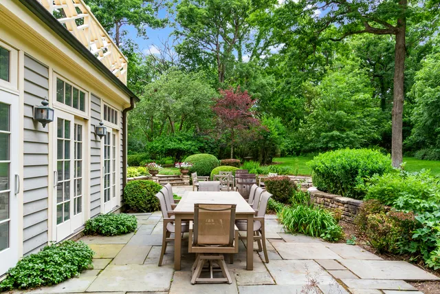 a view of a patio with table and chairs and potted plants