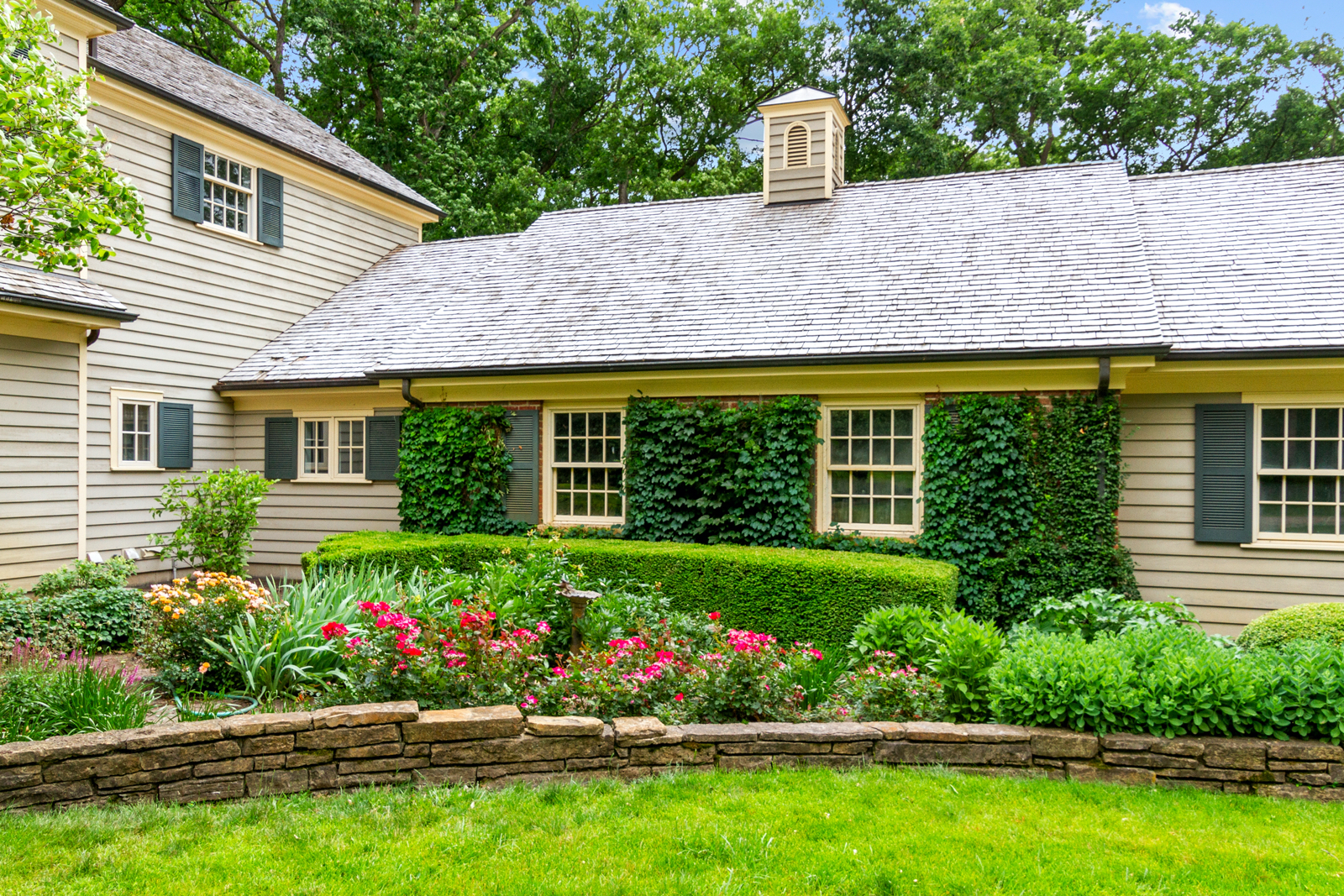 7208 White Oaks Road Harvard, IL 60033 - Photo 45 of 48 a front view of a house with a yard and a garden