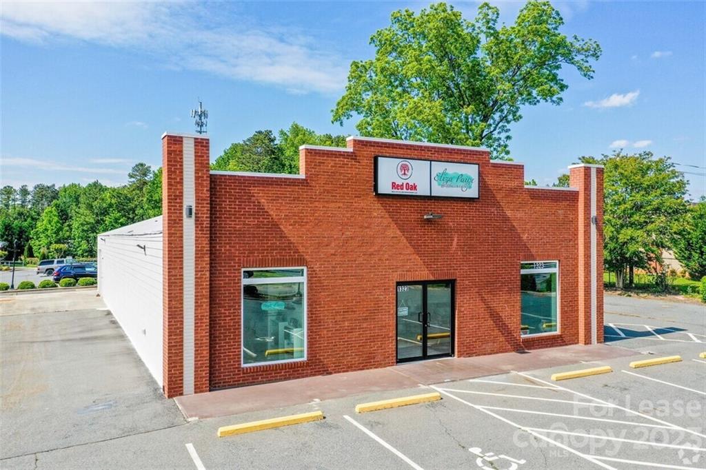 1323 Matthews-Mint Hill Road Matthews, NC 28105 - Photo 1 of 16 a front view of a house with a garden