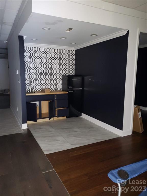 1323 Matthews-Mint Hill Road Matthews, NC 28105 - Photo 4 of 16 a kitchen with a sink and a refrigerator