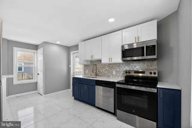 a kitchen with stainless steel appliances granite countertop a stove and a microwave