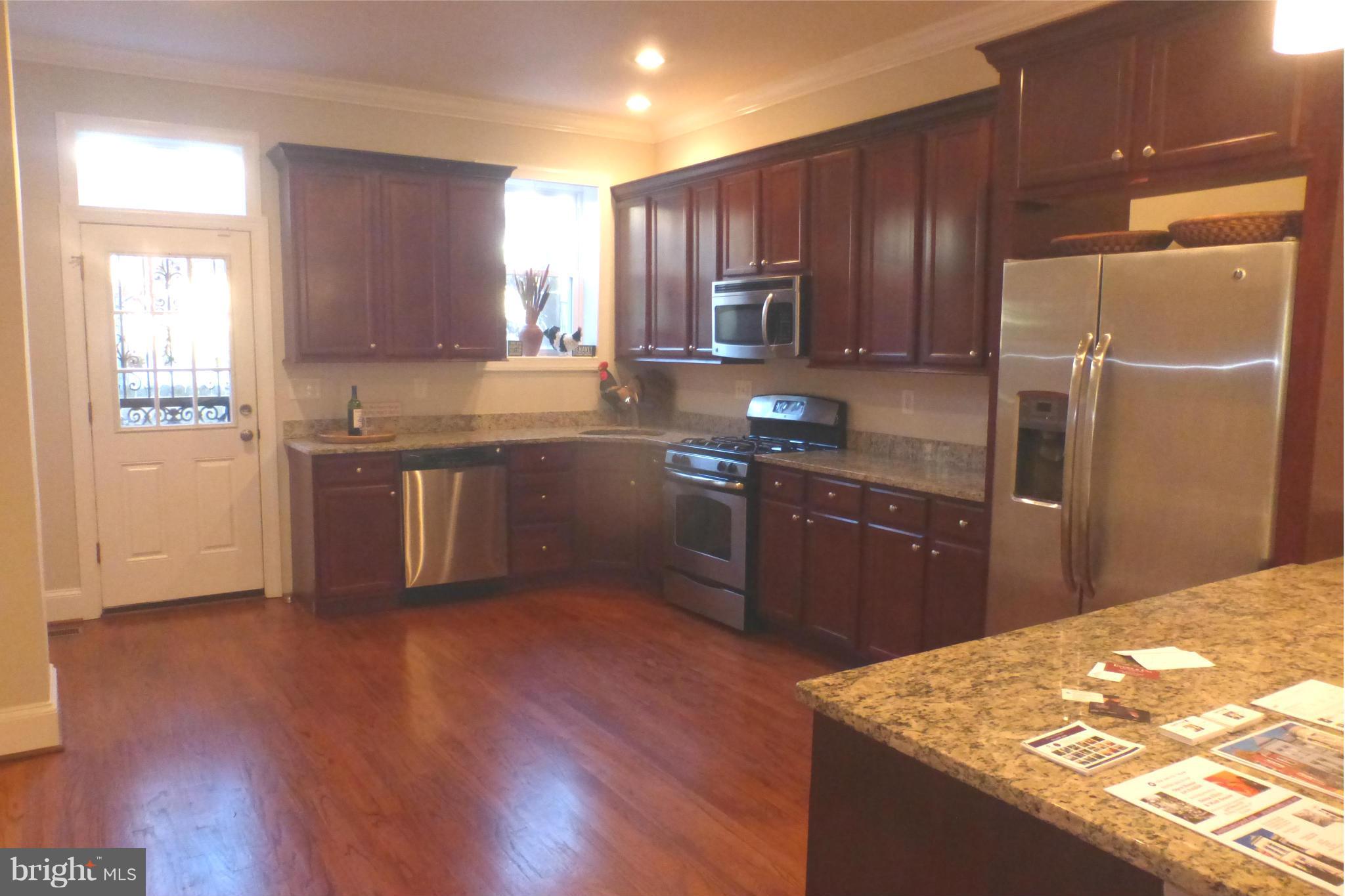 44 R Street Northeast Washington, DC 20002 - Photo 14 of 30 a kitchen with stainless steel appliances granite countertop a refrigerator a sink dishwasher a stove with wooden floors and cabinets