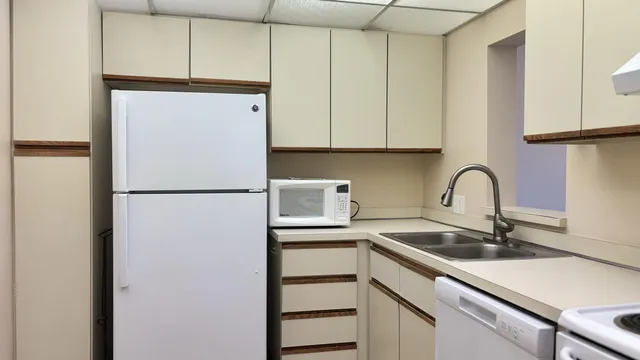 a kitchen with a refrigerator and a stove