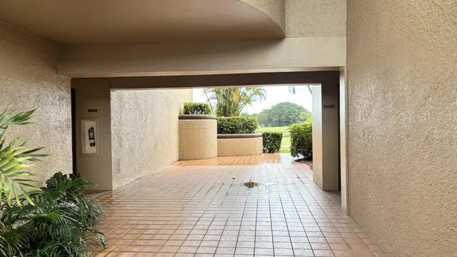 a view of a room with wooden floor and a floor to ceiling window