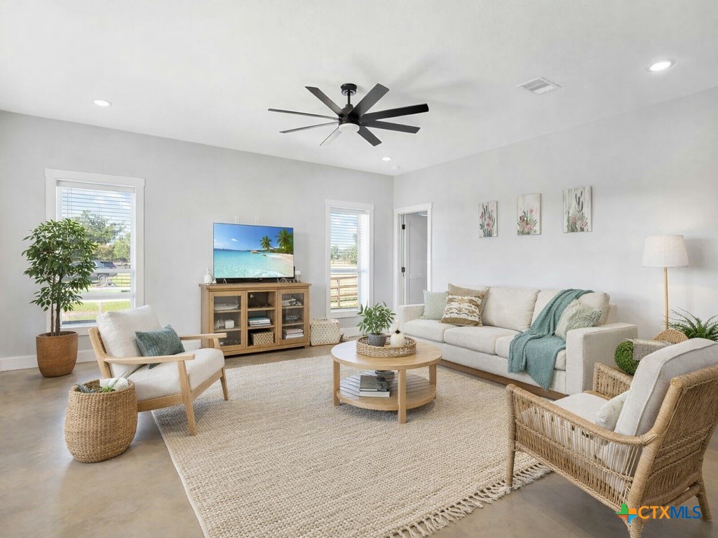 a living room with furniture a fireplace and a flat screen tv