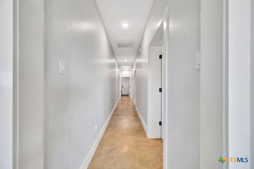 6887 Smith Dairy Road Belton, TX 76513 - Photo 11 of 48 a view of a hallway with wooden floor