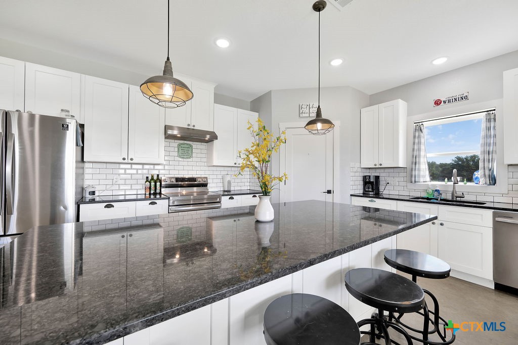 6887 Smith Dairy Road Belton, TX 76513 - Photo 13 of 48 a kitchen with sink cabinets and stainless steel appliances