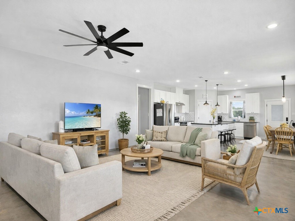 6887 Smith Dairy Road Belton, TX 76513 - Photo 16 of 48 a living room with furniture and a view of kitchen
