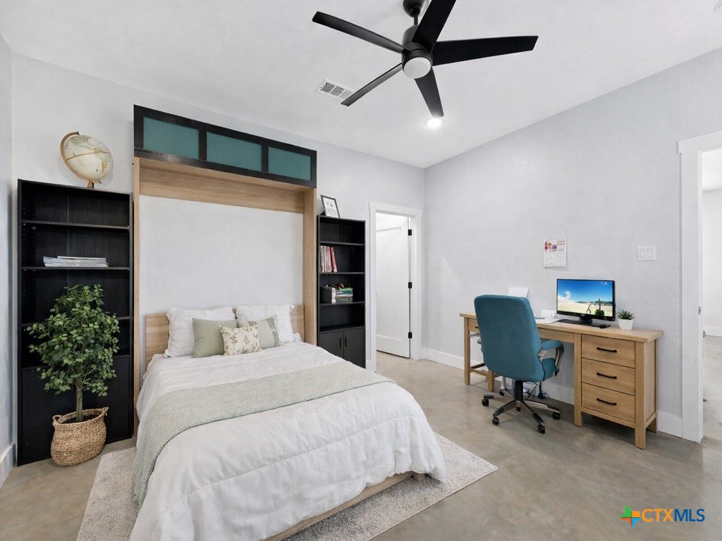 6887 Smith Dairy Road Belton, TX 76513 - Photo 17 of 48 a bedroom with a bed and a desk