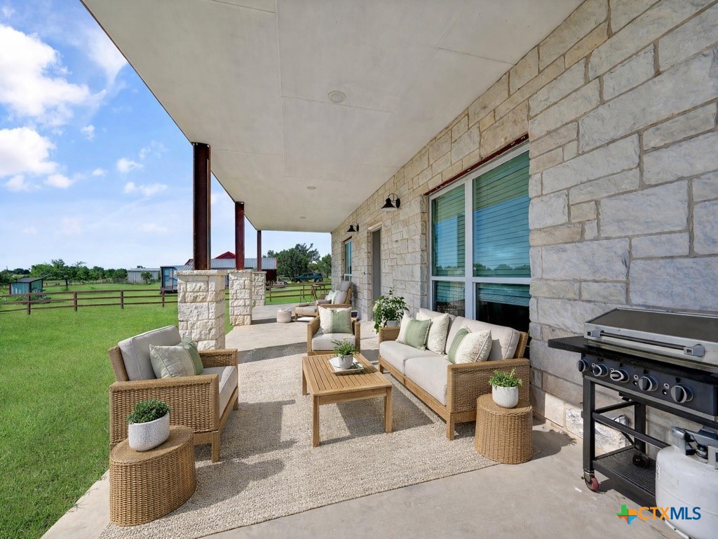 6887 Smith Dairy Road Belton, TX 76513 - Photo 18 of 48 a outdoor space with patio the couches and a potted plant on the table