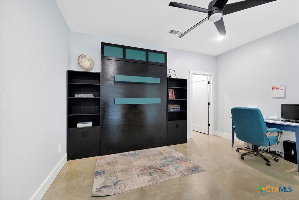 6887 Smith Dairy Road Belton, TX 76513 - Photo 19 of 48 a bedroom with a bed and a chair